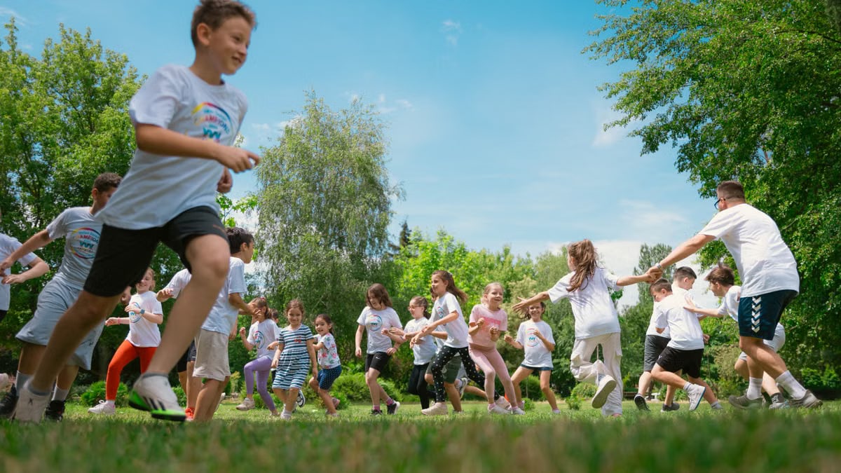 A group of children happily playing in a sunny park, enjoying outdoor activities and fun.